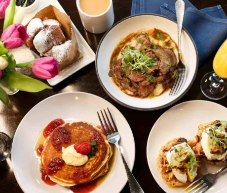 Delicious breakfast spread with pancakes, steak, and pastries at Dunhill Hotel, Charlotte.