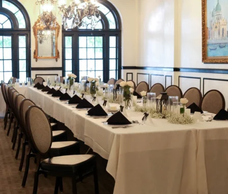 Elegant dining room with long table set for a family gathering at The Dunhill Hotel.