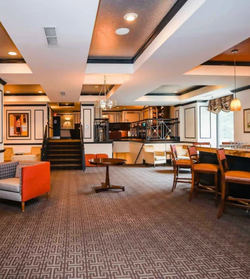 Elegant lobby of The Dunhill Hotel, with cosy seating and a welcoming bar.