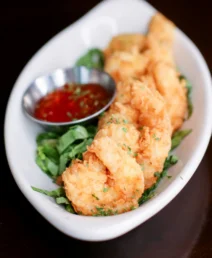 Crispy prawns with dipping sauce at boutique hotel restaurant.