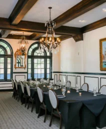 Elegant dining room with chandelier, set for a family gathering at The Dunhill Hotel.