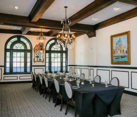 Elegant dining room with chandelier, set for a family gathering at The Dunhill Hotel.