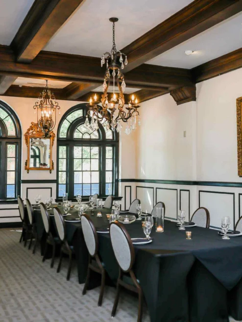 Elegant dining room with chandelier, set for a family gathering at The Dunhill Hotel.