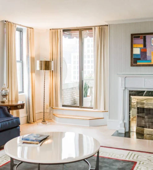 Elegant hotel suite lounge with cosy seating and modern art, ideal for relaxation.