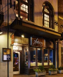 Charming exterior of The Dunhill Hotel in Charlotte at night with warm lighting.