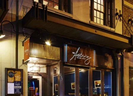 Charming exterior of The Dunhill Hotel in Charlotte at night with warm lighting.