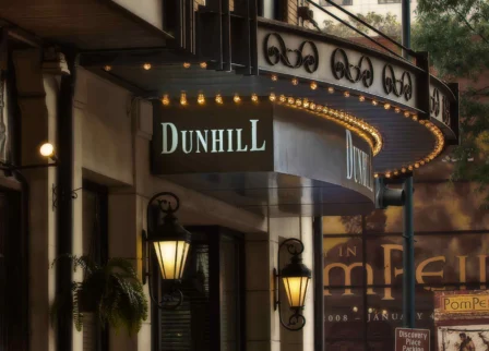 Elegant entrance of The Dunhill Hotel with classic lanterns and inviting signage.