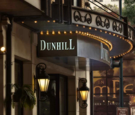 Elegant entrance of The Dunhill Hotel with classic lanterns and inviting signage.
