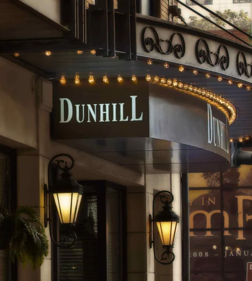 Elegant entrance of The Dunhill Hotel with classic lanterns and inviting signage.