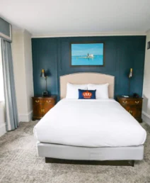 Elegant hotel room with cosy bed and nautical-themed decor at The Dunhill Hotel.