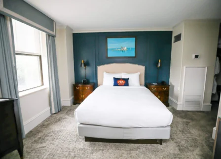 Elegant hotel room with cosy bed and nautical-themed decor at The Dunhill Hotel.