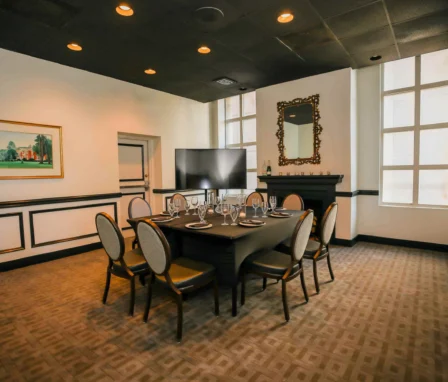Elegant dining room setup in the Dunhill Hotel, featuring a large table and ambient lighting.