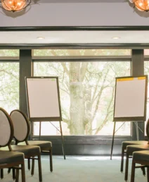 Elegant meeting room in The Dunhill Hotel with chairs and presentation boards.