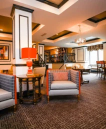 Elegant hotel lounge with cosy seating and inviting bar area, perfect for relaxation.
