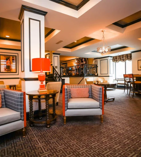 Elegant hotel lounge with cosy seating and inviting bar area, perfect for relaxation.