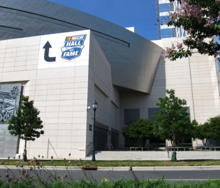 A large white building with a sign reading NASCAR Hall of Fame.